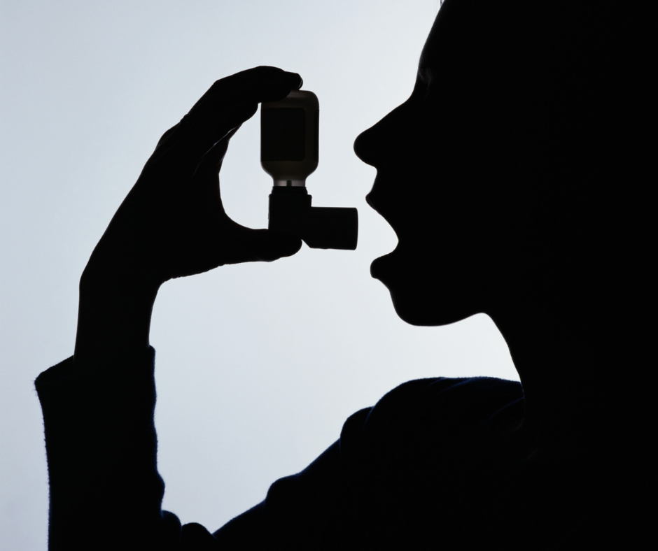 Shadow silhouette putting an asthma inhaler to their mouth