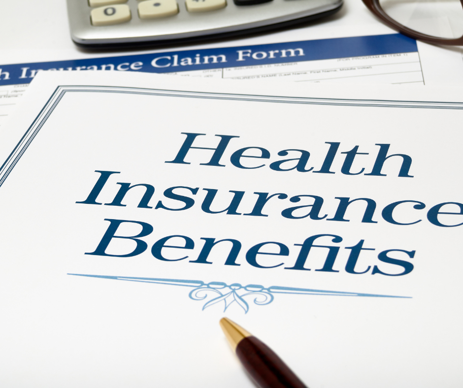 Paper that says Health Insurance Benefits with decorative flair beneath.