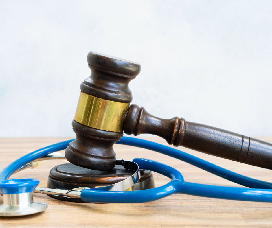 Picture of a gavel on top of a stethoscope. 