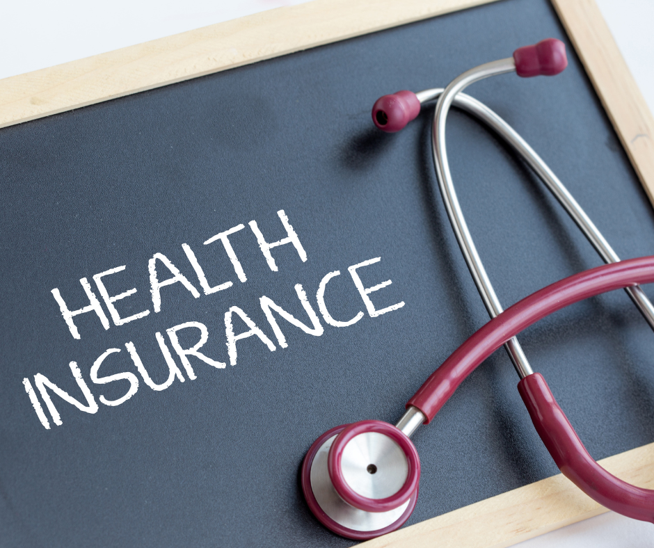 A chalkboard with the words "health insurance." A maroon stethoscope is on the chalkboard