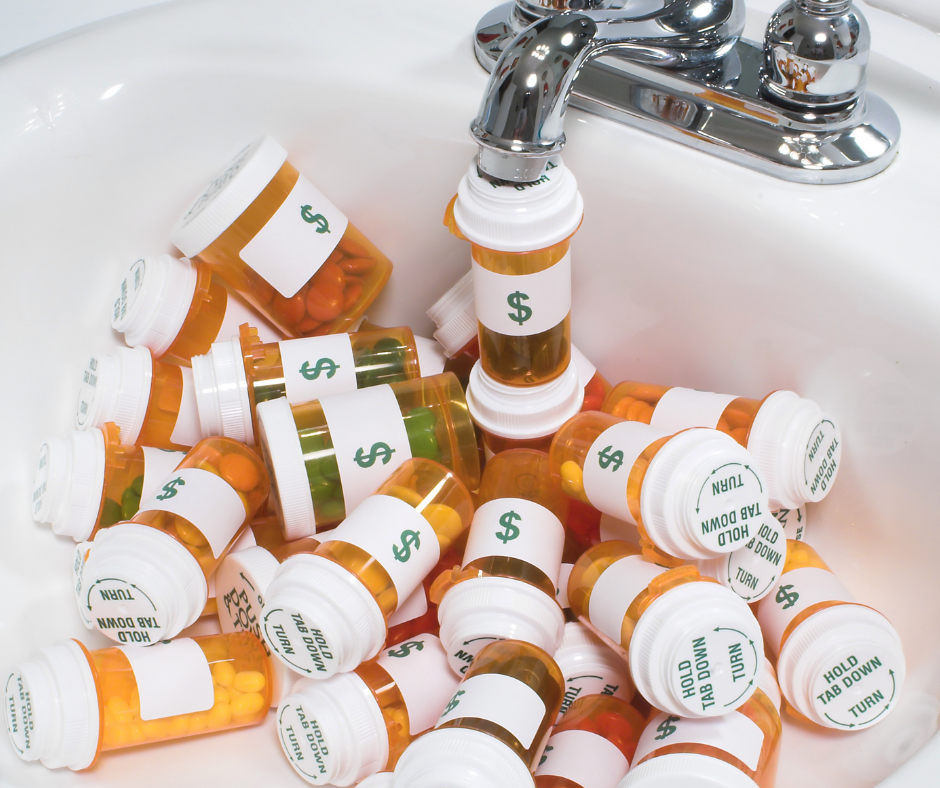 Pill bottles with dollar bills in a sink. 