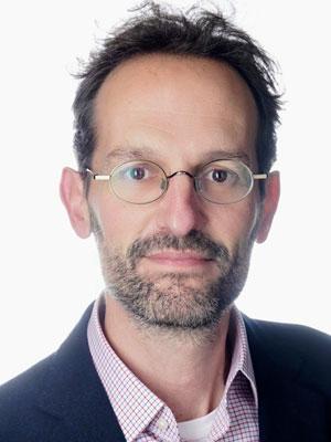 Male with dark hair and glasses