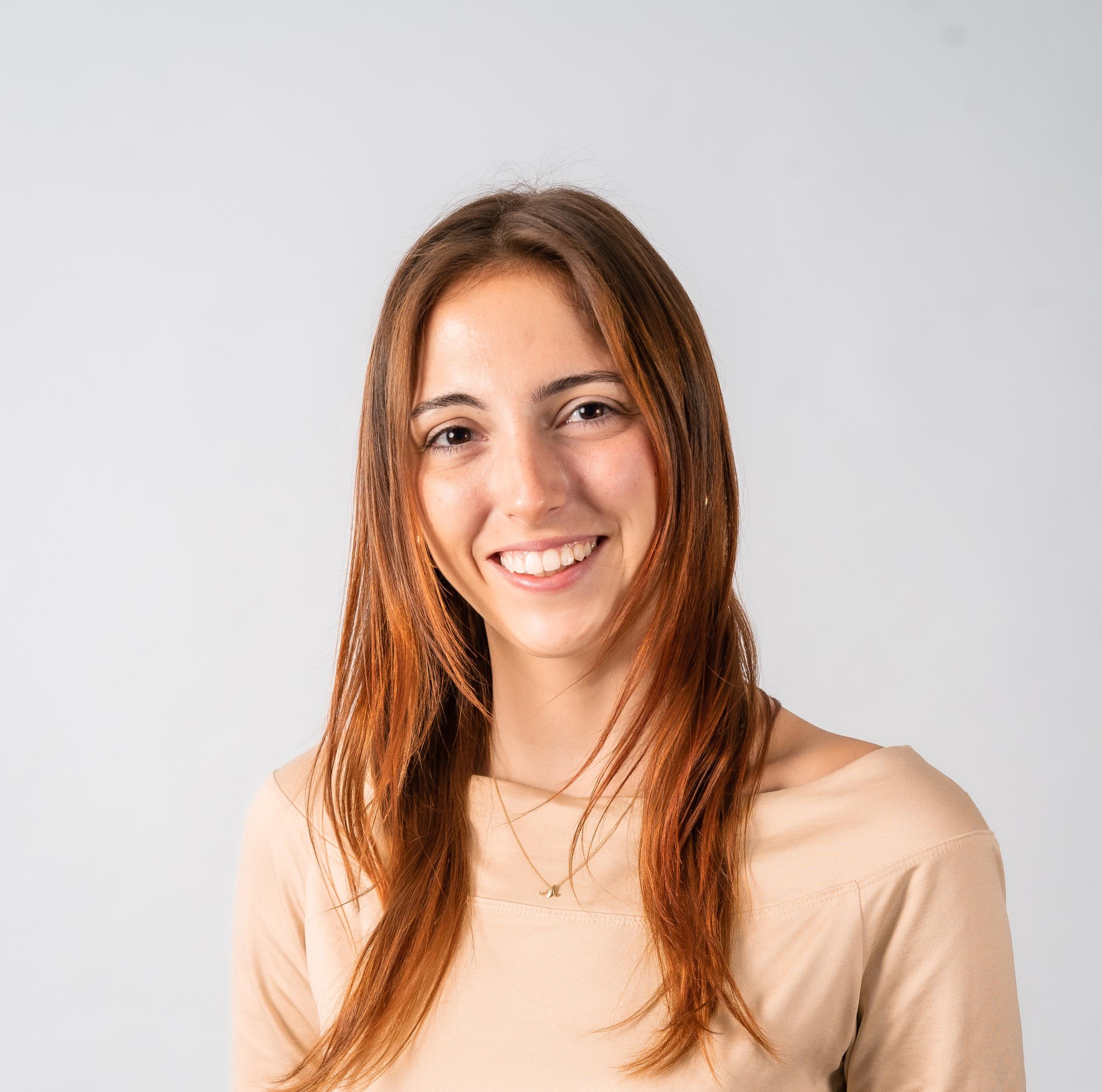 Woman with long hair in front of a light grey background