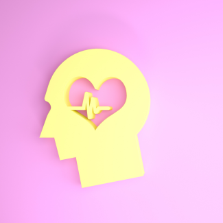 A silhouette of a yellow human head with a heart and cardiogram where the brain is located, on a pink background